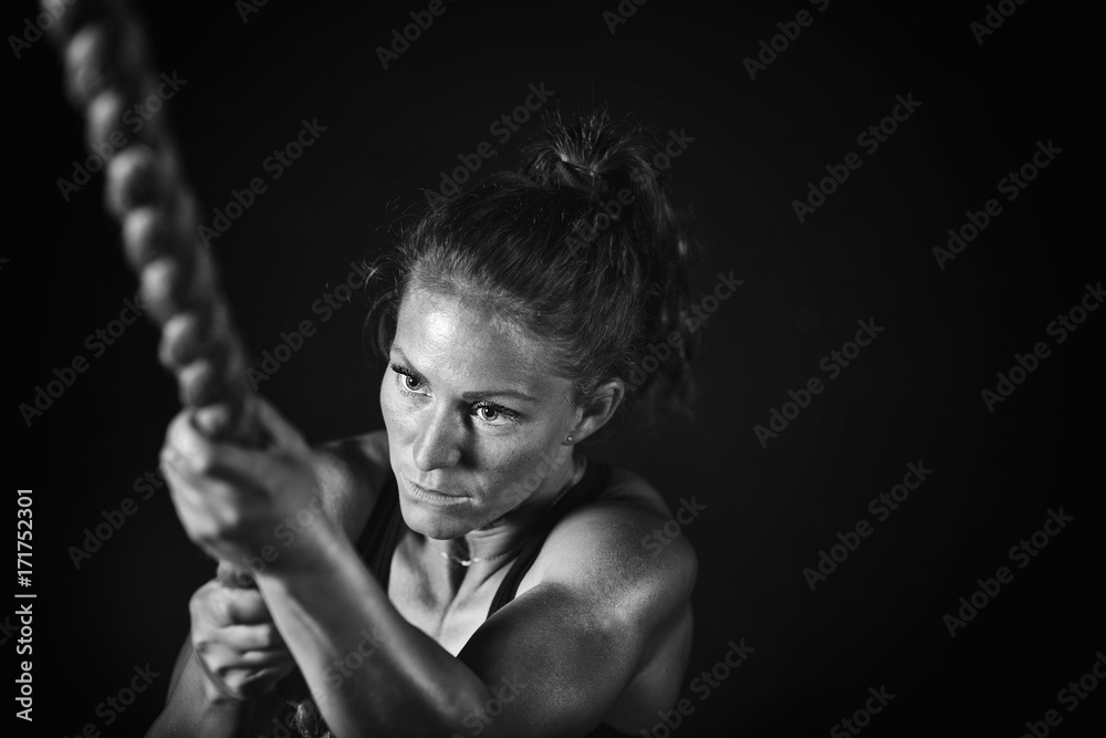 Woman athlete exercising on gymnastic rings Woman athlete exercising on gymnastic rings