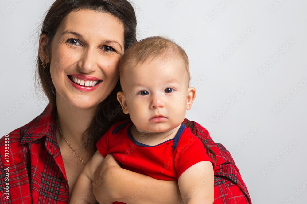 Portrait of a happy family. Smiling woman with a baby in her arms. Mother and baby Portrait of a happy family. Smiling woman with a baby in her arms. Mother and baby