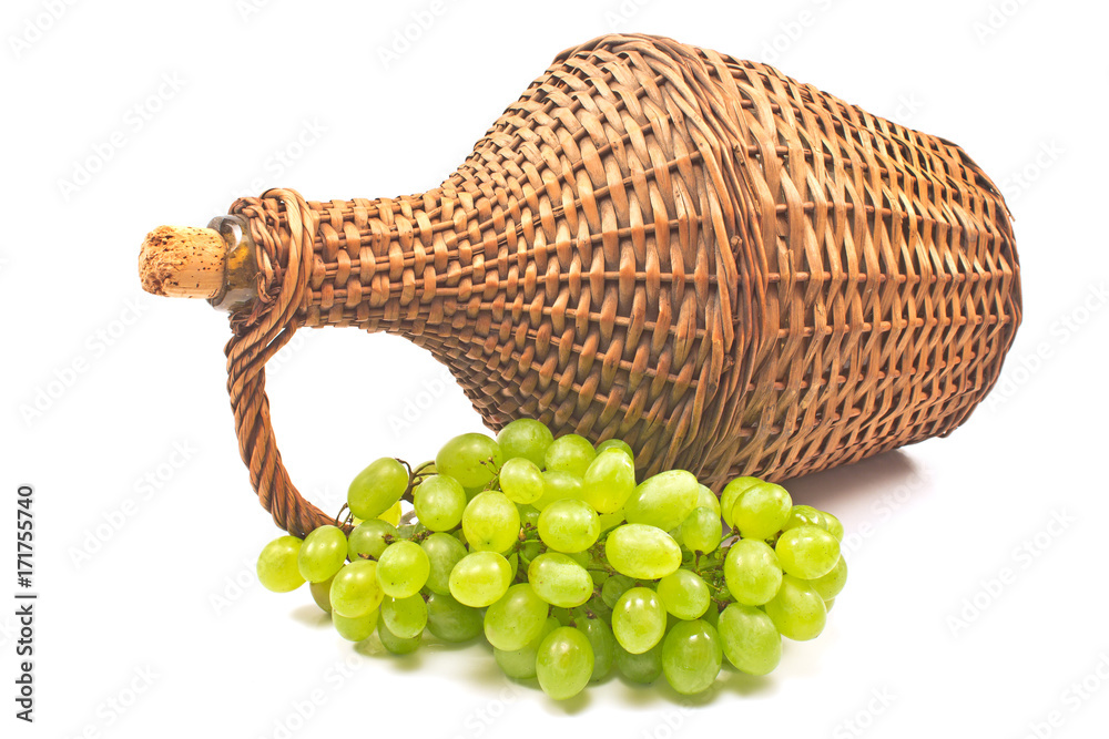 Obraz premium White grape with old wicker wrapped glass bottle isolated on white background