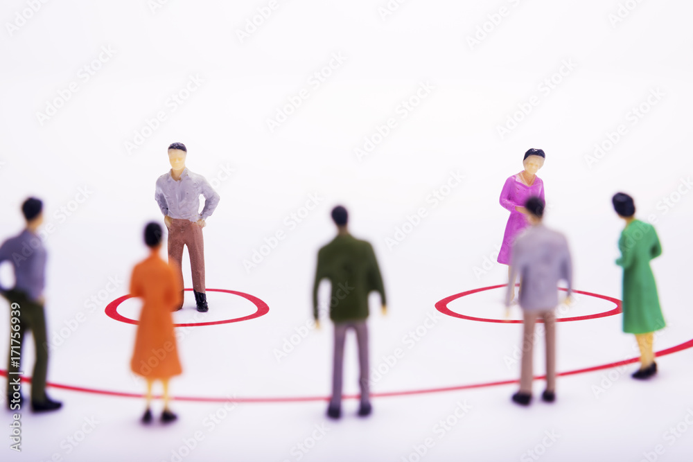 Miniature business people standing in diagrams, smile over white bacground.