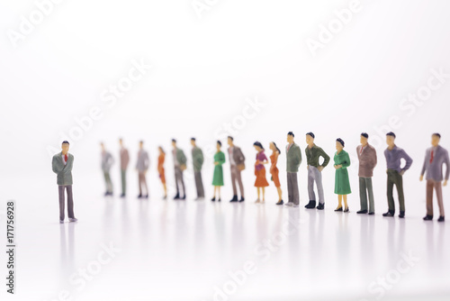 Miniature people  boss against the line of people over white background.