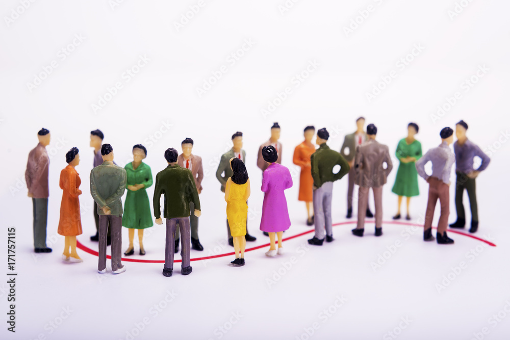 Group of miniature people over white background standing in line. Group of miniature people over white background standing in line.