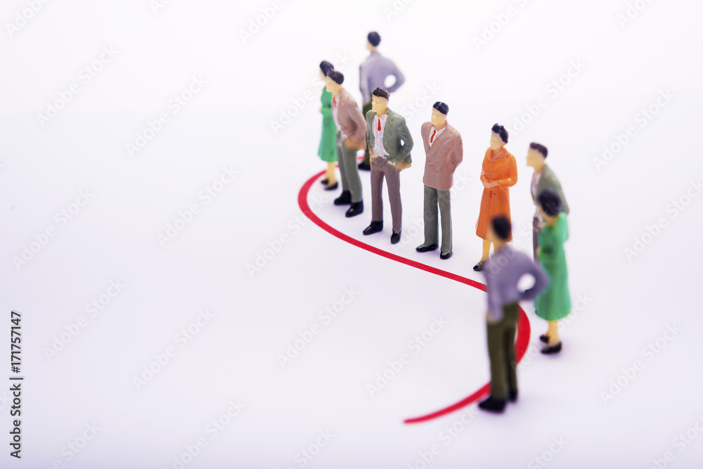 Group of miniature people over white background standing in line. Group of miniature people over white background standing in line.