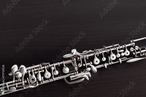 Musical background, poster - oboe on black background .  Free space for text.