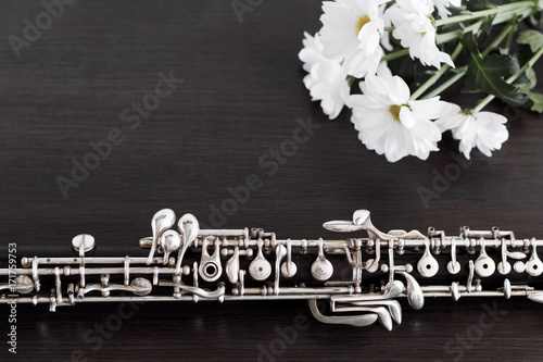 Musical background, poster - oboe on black background with flowers .  Free space for text. photo