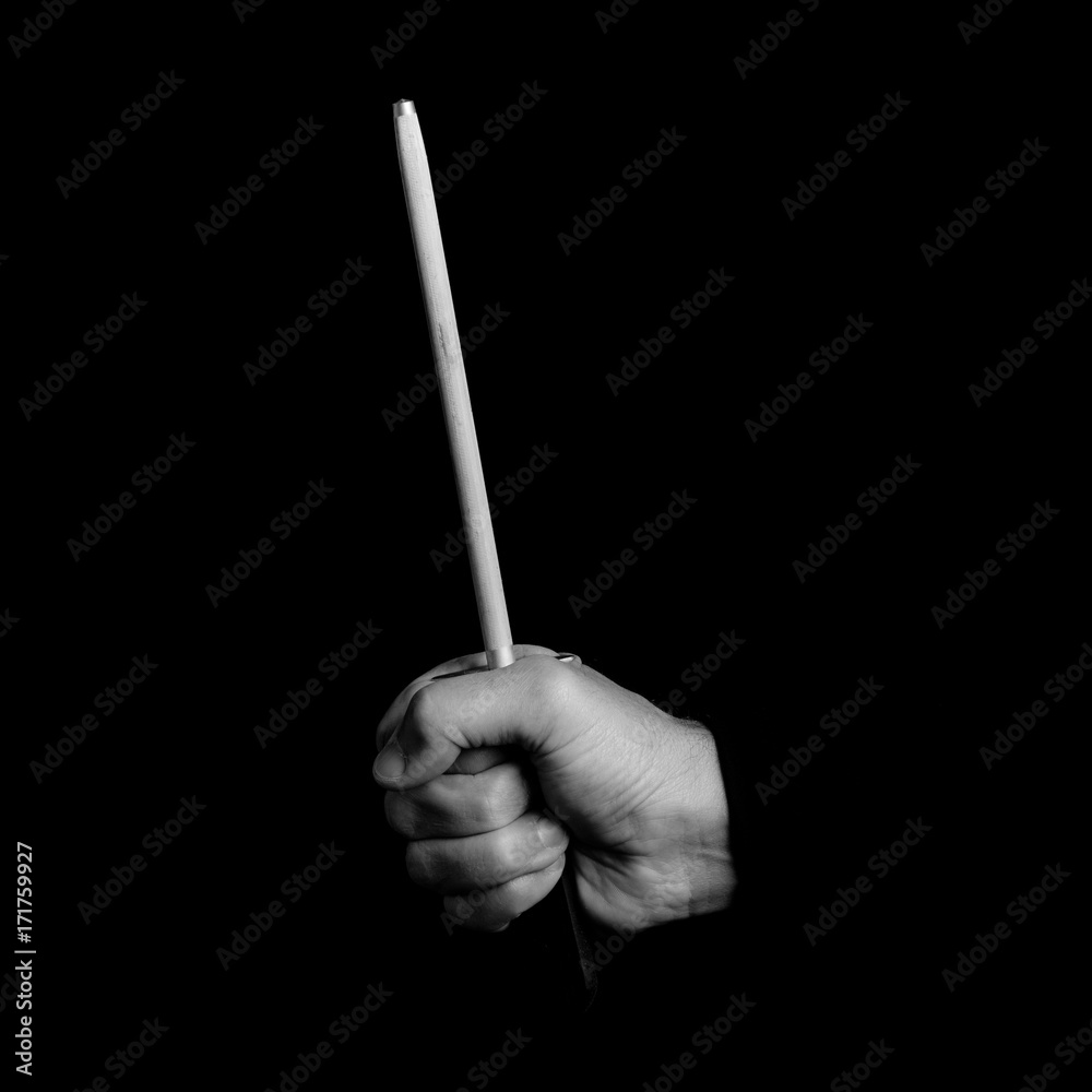 Fototapeta premium sharpener - kitchen tools in a man's hand - black and white photo