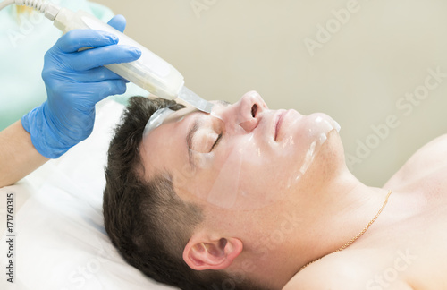 Man in the mask cosmetic procedure in spa salon 