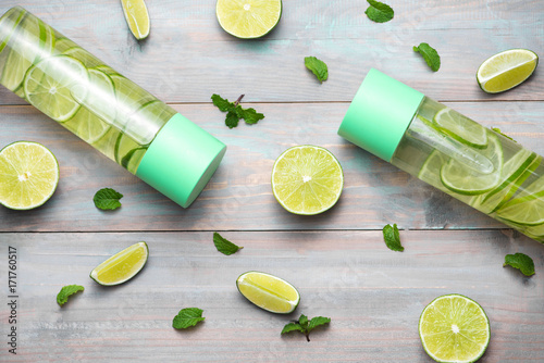 Detox Infused Water with Lime and Mint in Sports Bottle, with slices of lime.