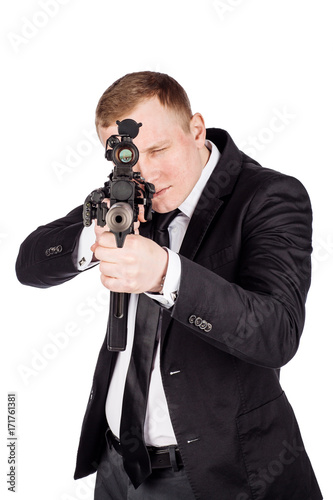 Secret aghent or spy holds rifle with silincer in hand. Isolated on white background. photo