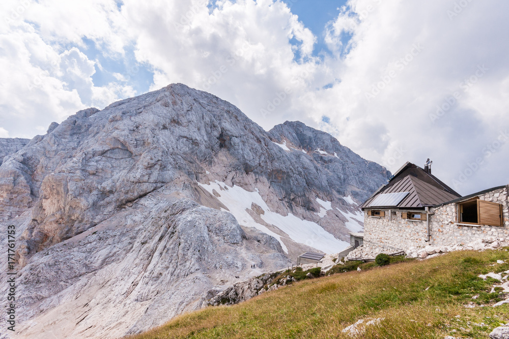 Kredarica - highest mountain hut in Slovenia and climb to Mt. Triglav in the background. Kredarica - highest mountain hut in Slovenia and climb to Mt. Triglav in the background.