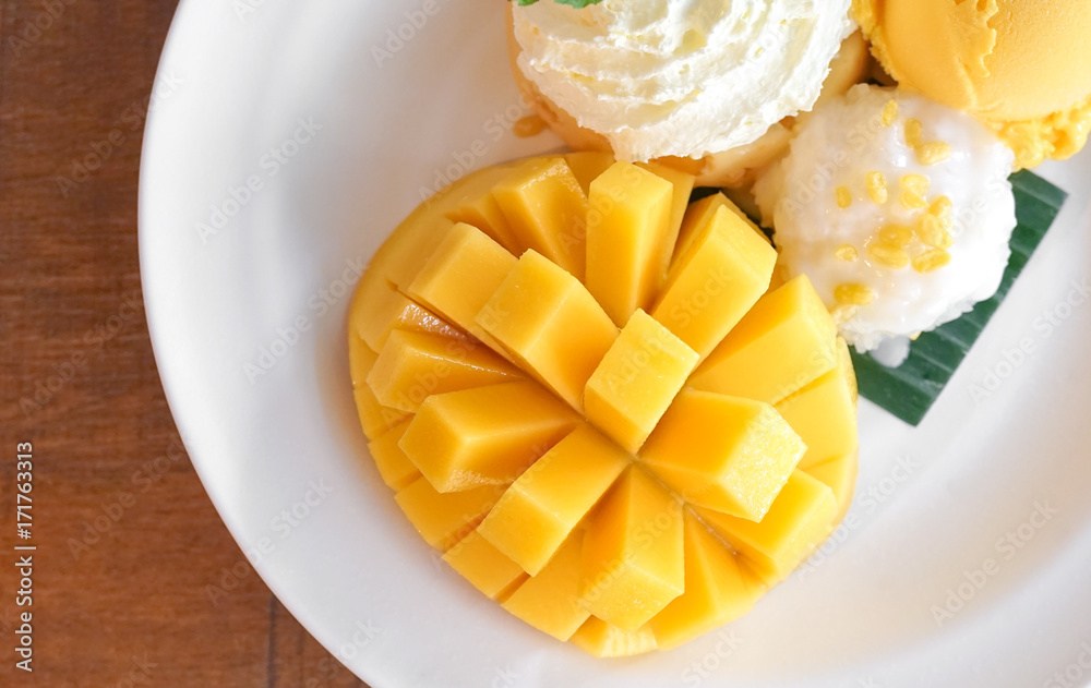Mango sticky rice served with mango sherbet ice cream, summer dessert. Mango sticky rice served with mango sherbet ice cream, summer dessert.
