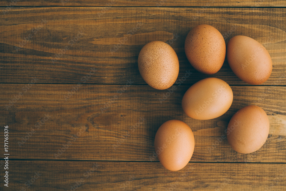 Fresh brown eggs on a wooden background Fresh brown eggs on a wooden background