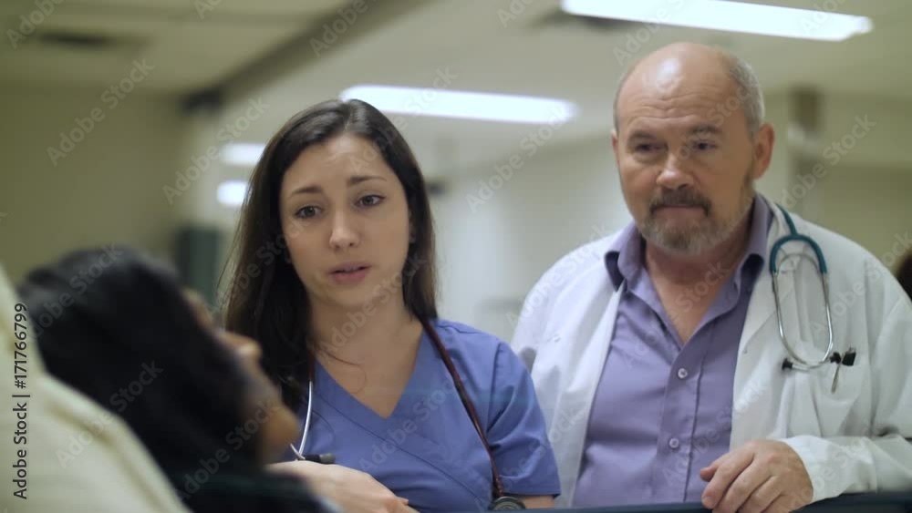 Caring doctor and nurse deliver bad news to a patient bedside in hospital. Caring doctor and nurse deliver bad news to a patient bedside in hospital.
