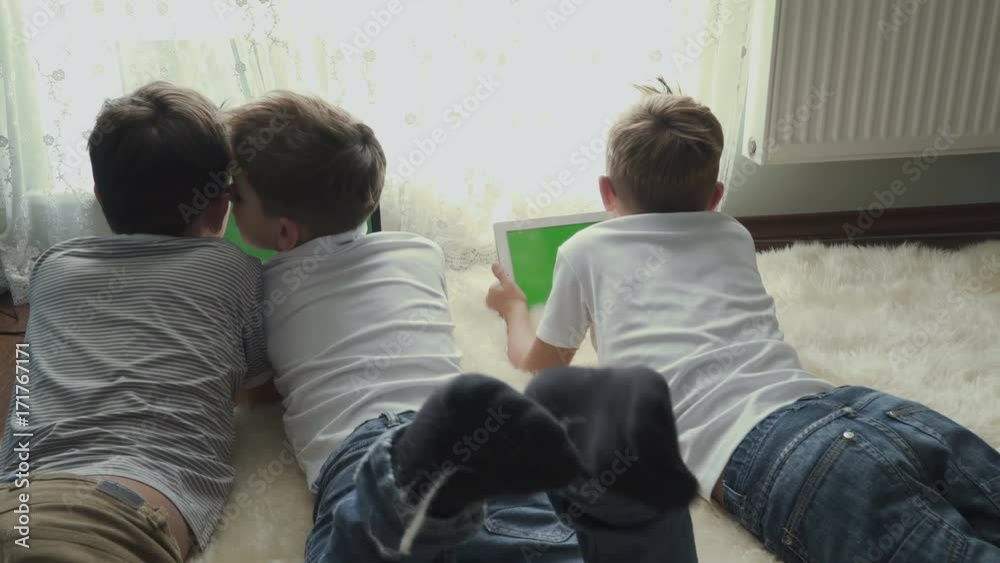 Little boys uses electronic gadgets at home