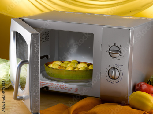  pan of baked potatoes into microwave oven