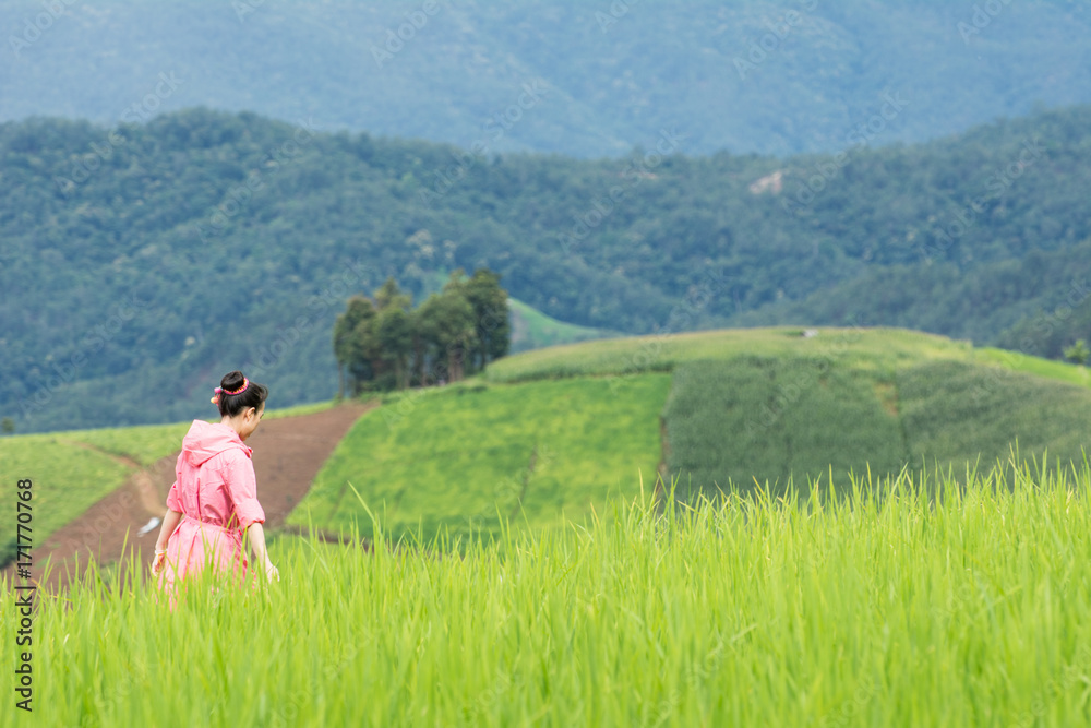 Asian woman relaxing in rice terraces fields on holiday