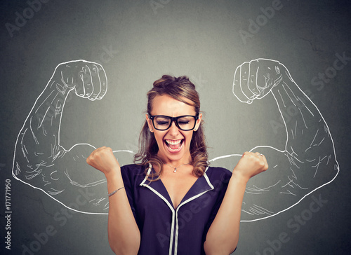 happy woman exults pumping fists celebrates success