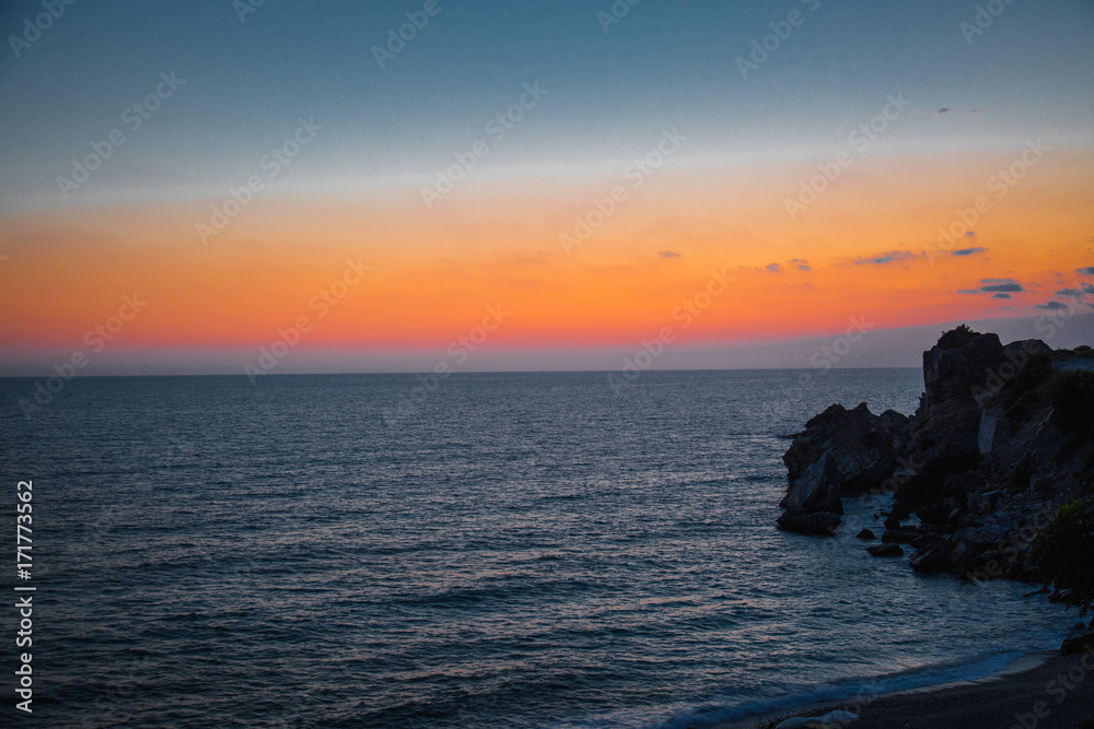 Sunset over the sea and rocks