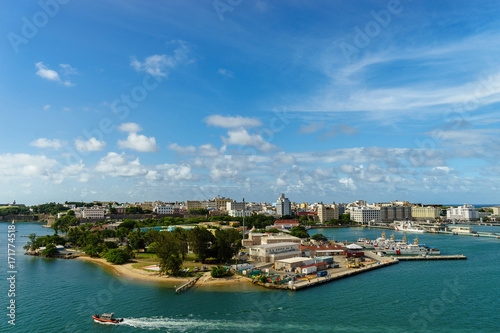 Scenic view of historic colorful Puerto Rico city in distance from the sea with the port in foreground © Hladchenko Viktor