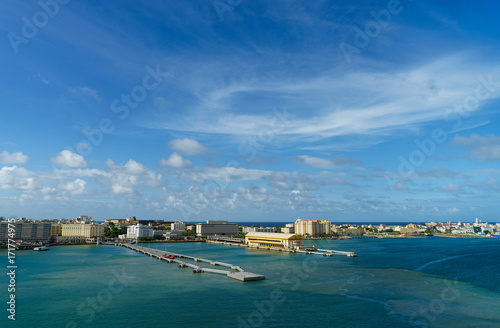 Scenic view of historic colorful Puerto Rico city in distance from the sea with the port in foreground photo