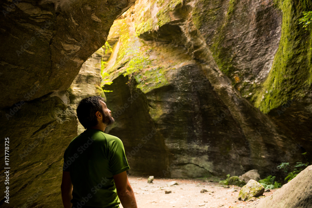 Young adult active man exploring scenic gorge in Uriezzo Italy in sunny summer day outdoor. Young adult active man exploring scenic gorge in Uriezzo Italy in sunny summer day outdoor.