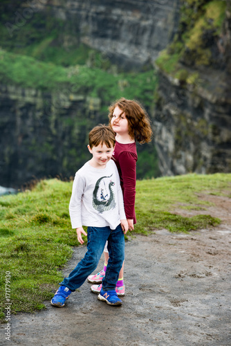 Boy and Girl walking up the Cliffs of Moher Tourist Attraction in Ireland