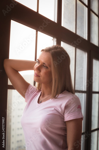 pensive sexy girl by the window, emotions