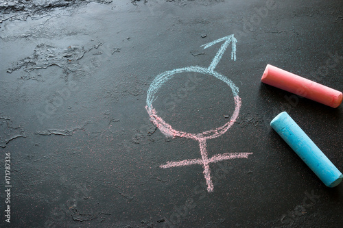 Colorful crayons and a symbol of a transgender