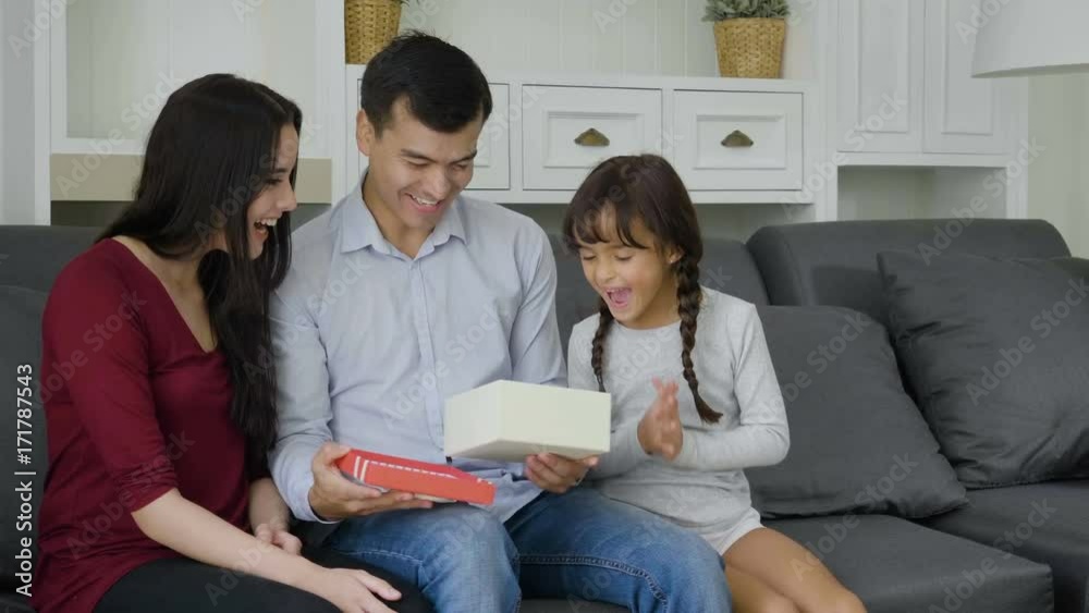 Surprised Father receiving gift box from daughter Surprised Father receiving gift box from daughter
