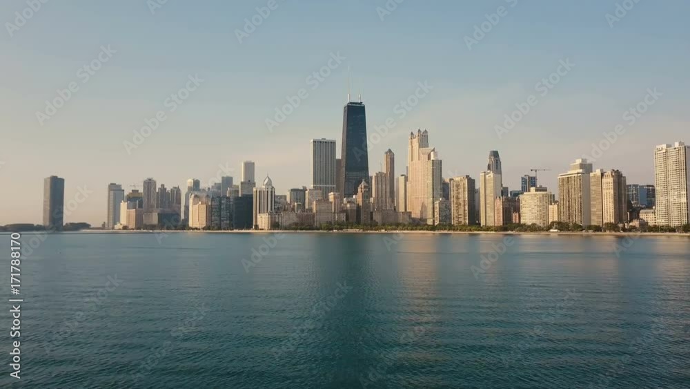 Aerial view of the Michigan lake and Chicago, America. Drone flying low over the water to the downtown in the morning. Aerial view of the Michigan lake and Chicago, America. Drone flying low over the water to the downtown in the morning.