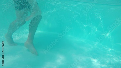 Couple playing and kissing romantically in the pool underwater
