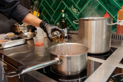 Chef is adding white wine to a dish