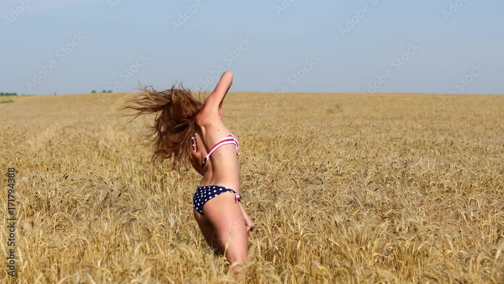 Dancer Hip Hop. Sexy young girl in bikini dancing in a wheat field Dancer Hip Hop. Sexy young girl in bikini dancing in a wheat field