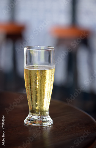 Glass of beer on a table of popular bar