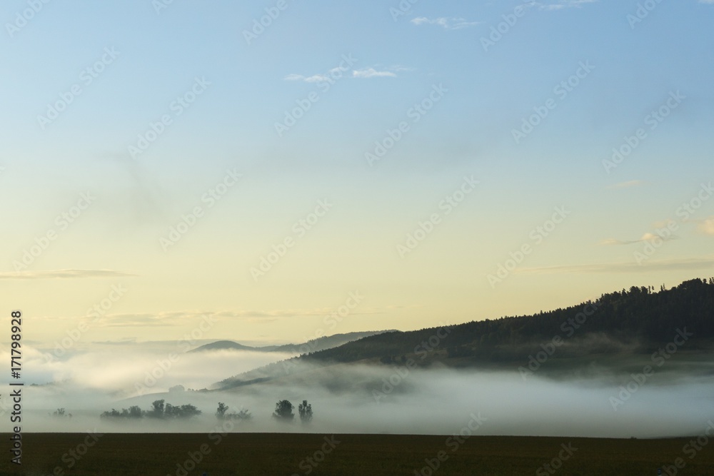 Fototapeta premium Sunrise and sunset over the hills and town. Slovakia