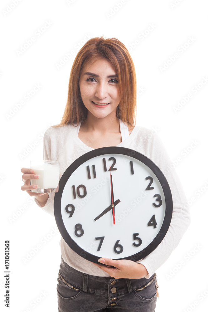 Healthy Asian woman drinking glass of milk hold clock. Healthy Asian woman drinking glass of milk hold clock.