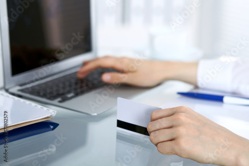 Close up of business woman hands typing on laptop computer