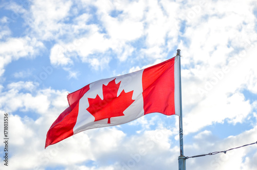 Waving flag Canada under the blue sky