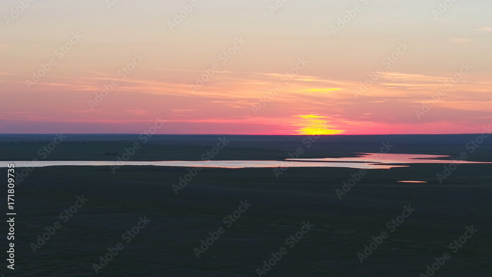 Aerial view of beautiful emerald green water lake and summer landscape sunset. Sunset on the lake