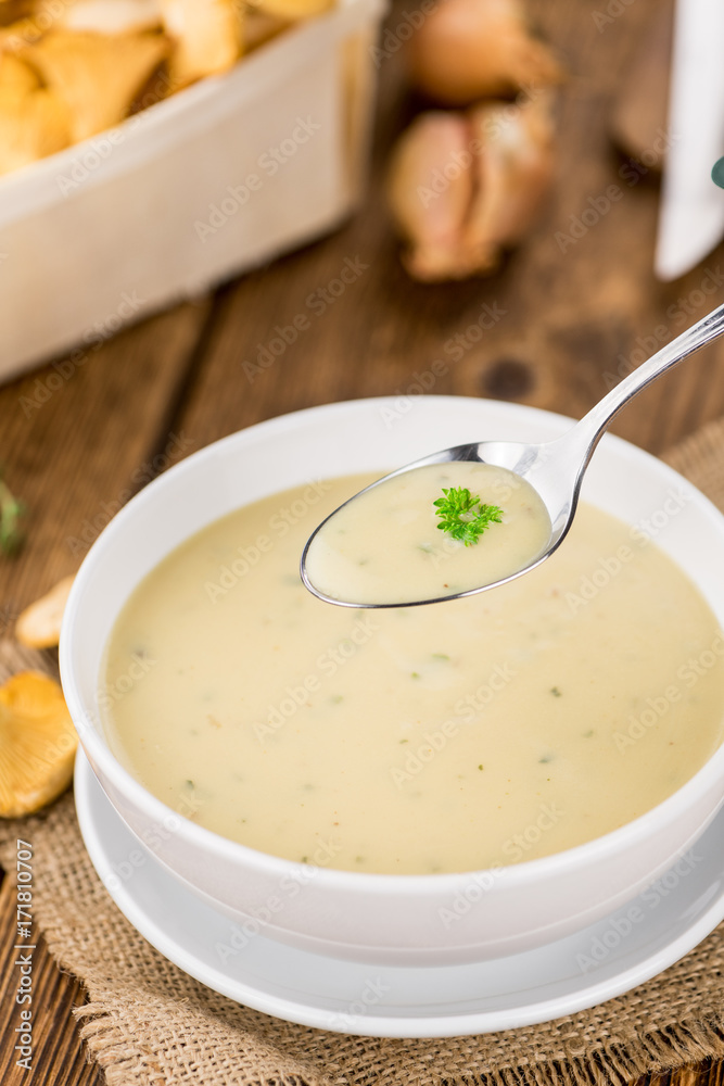 Chanterelle Soup on wooden background; selective focus Chanterelle Soup on wooden background; selective focus