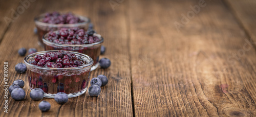 Portion of Blueberries (preserved) on wooden background, selective focus