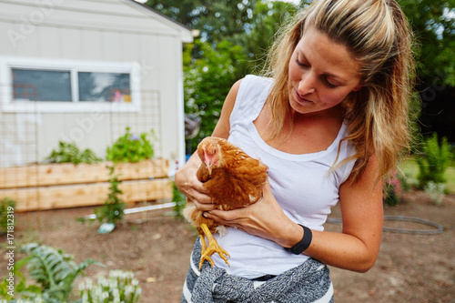 rural beautiful woman holding chicken