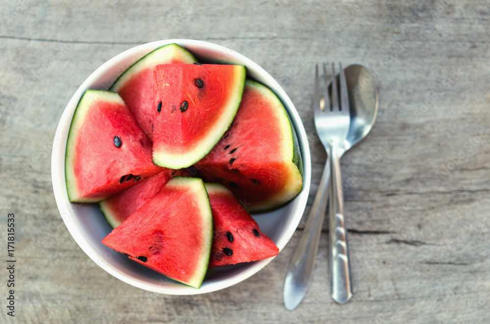 fresh slice of watermelon in cup on woods background fresh slice of watermelon in cup on woods background
