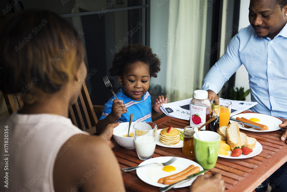 Black family having breakfast together Black family having breakfast together