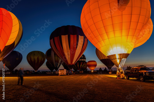 hot air balloons glowing in night sky