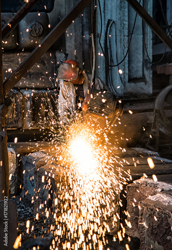 The workers in the steel mill are burnishing the steel