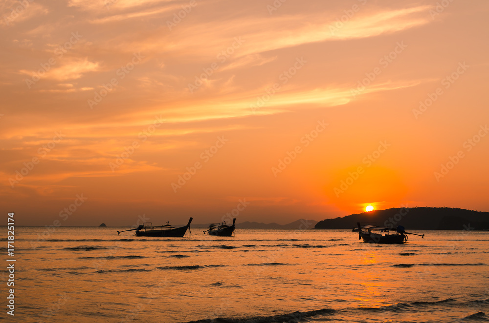 Sea in sunset light with fishing boat.
