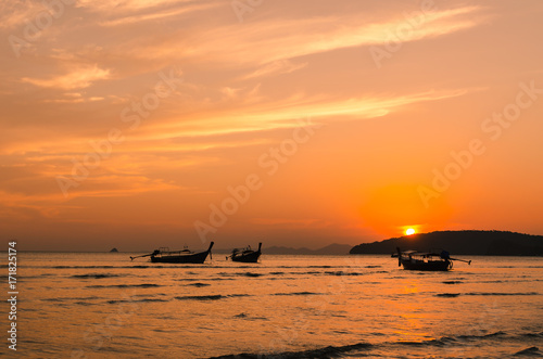 Sea in sunset light with fishing boat.