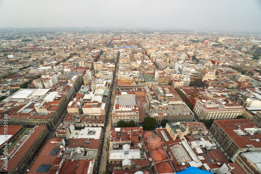 Bird's-eye panoramic view to roofs of ancient houses, buildings, central square park and streets in the city at summer sunny day