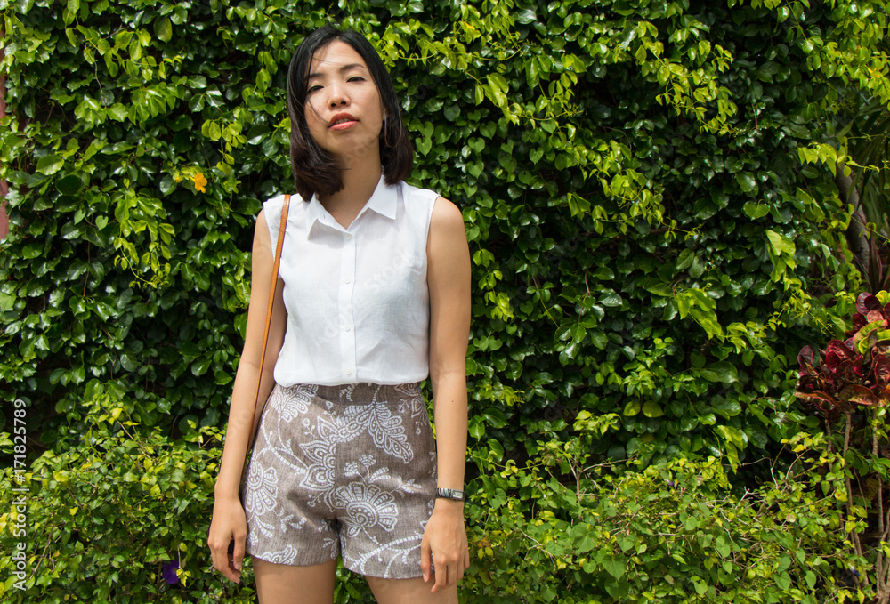 an asian young woman is standing an asian young woman is standing